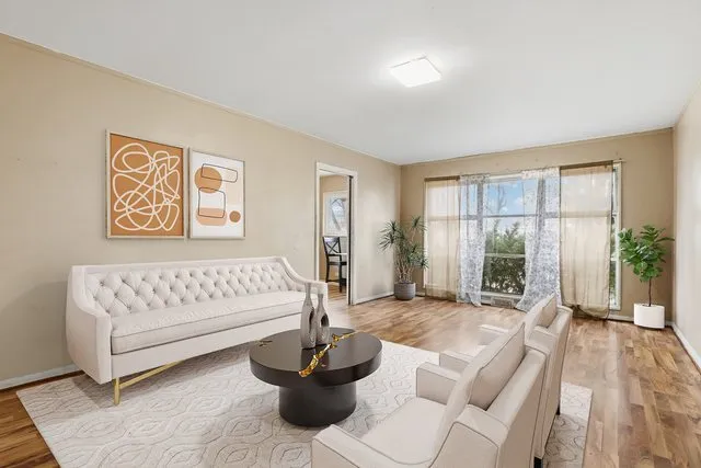 a spacious bedroom with a bed and a large window