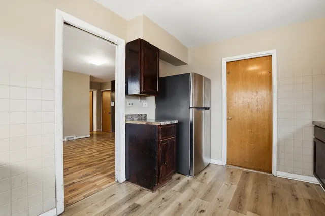 a kitchen with a refrigerator and a sink