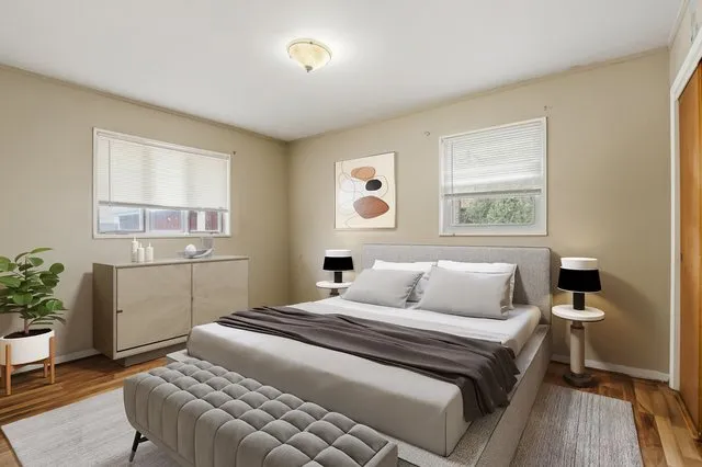 a bedroom with a bed and a potted plant