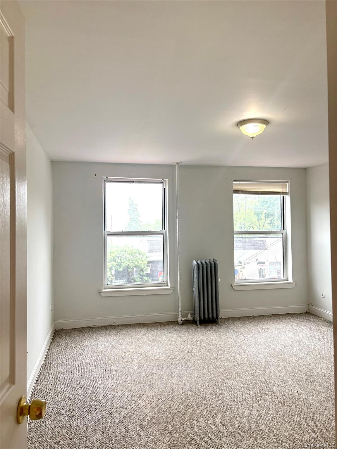 2 Morris Avenue, Unit 203 Cold Spring, NY 10516 - Photo 18 of 32 an empty room with a window and a mirror