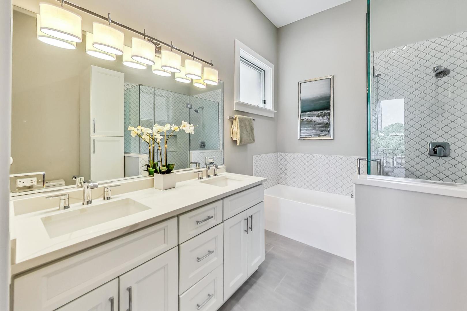 2035 North Leavitt Street, Unit 2 Chicago, IL 60647 - Photo 13 of 44 a bathroom with a sink double vanity granite tub shower and a mirror