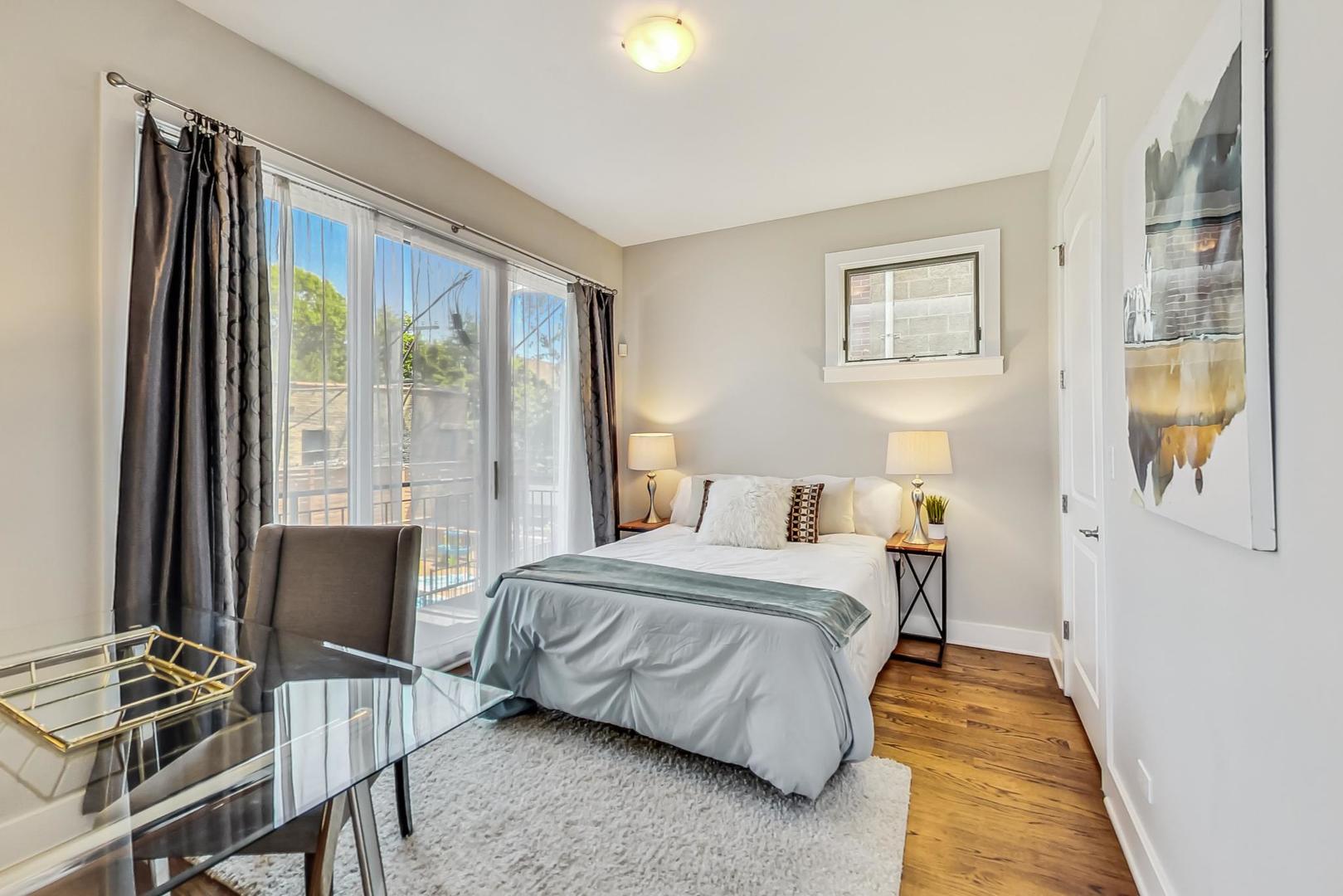 2035 North Leavitt Street, Unit 2 Chicago, IL 60647 - Photo 19 of 44 a bedroom with a bed and wooden floor
