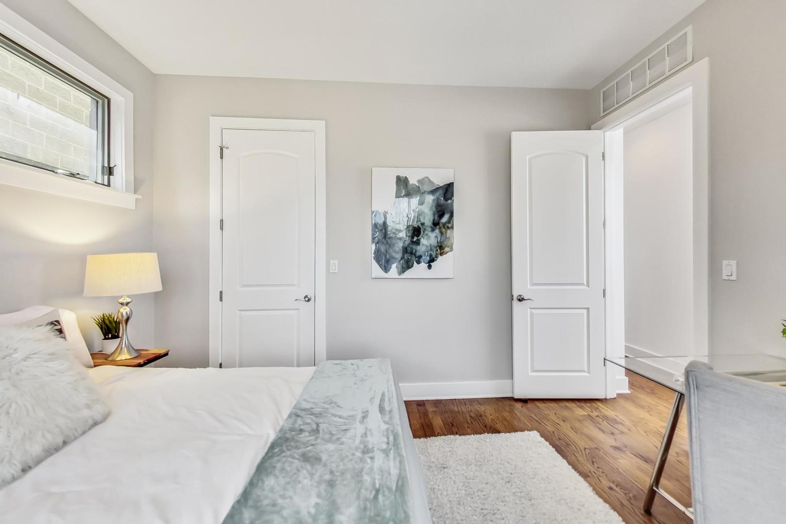 2035 North Leavitt Street, Unit 2 Chicago, IL 60647 - Photo 21 of 44 a bedroom with a bed and wall painting