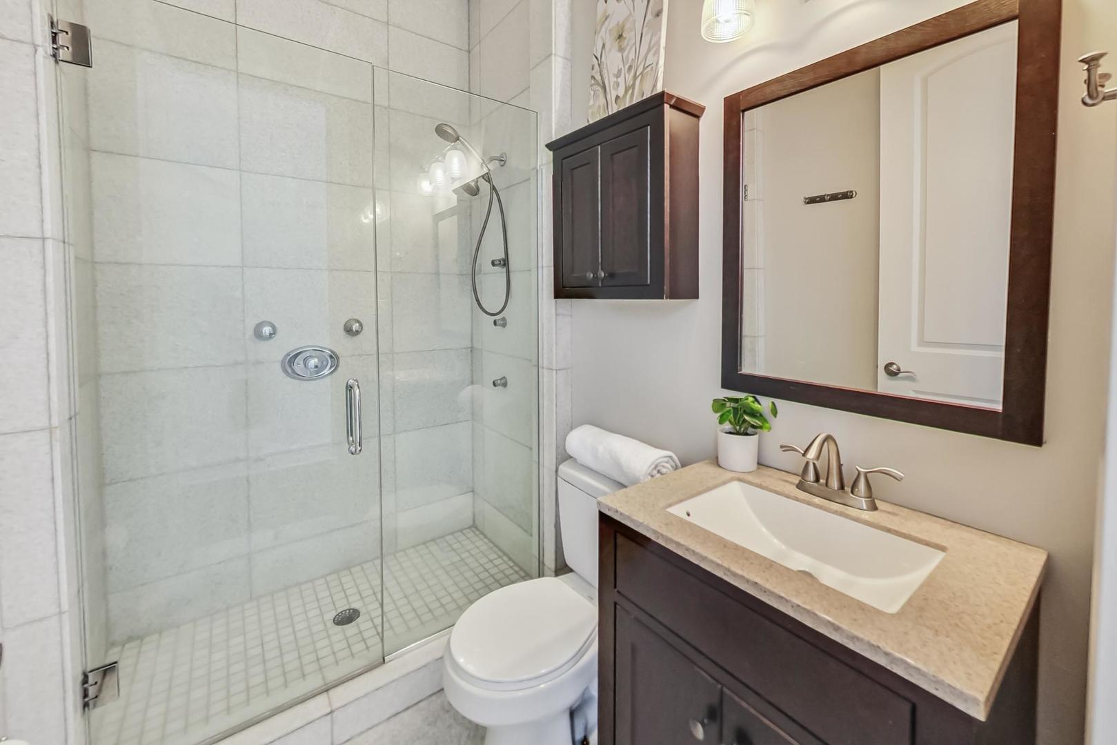 2035 North Leavitt Street, Unit 2 Chicago, IL 60647 - Photo 22 of 44 a bathroom with a sink toilet double vanity and shower