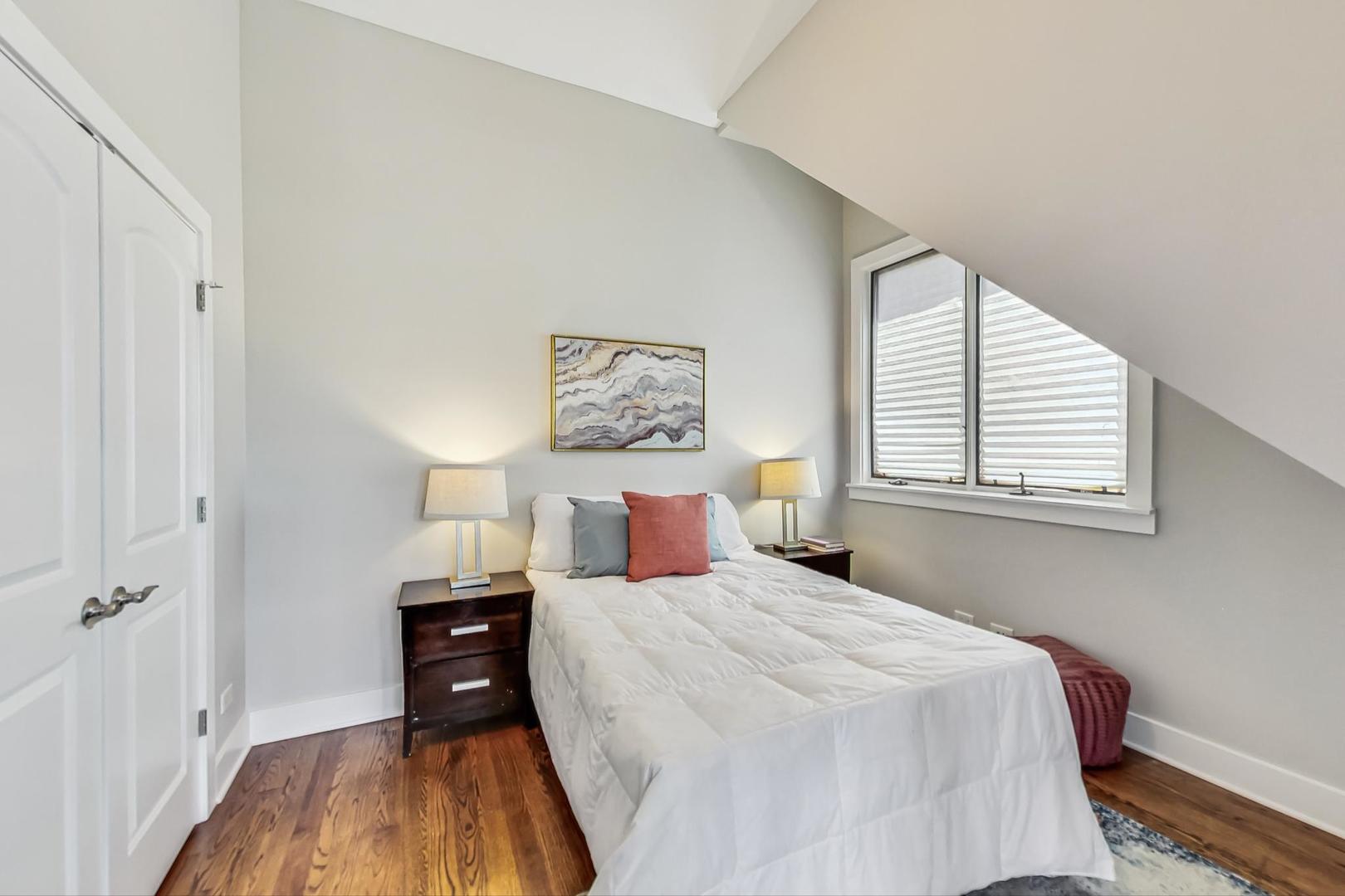 2035 North Leavitt Street, Unit 2 Chicago, IL 60647 - Photo 27 of 44 a bedroom with a bed and a wooden floor