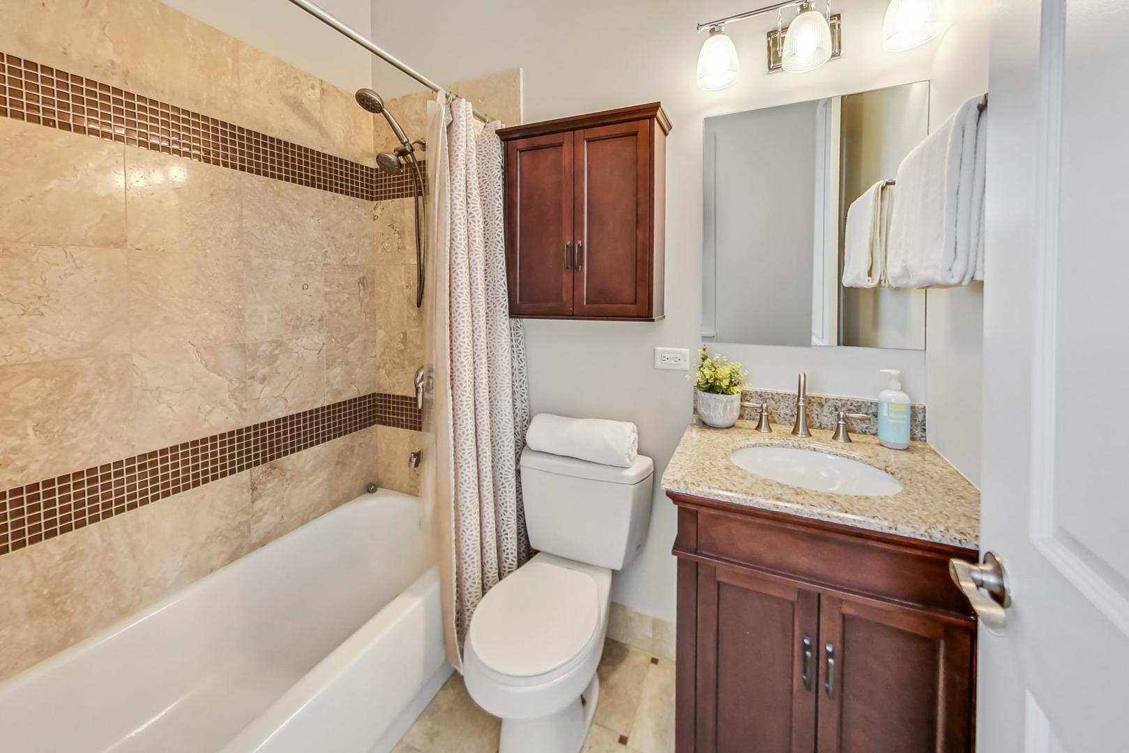 2035 North Leavitt Street, Unit 2 Chicago, IL 60647 - Photo 29 of 44 a bathroom with a granite countertop sink toilet and shower