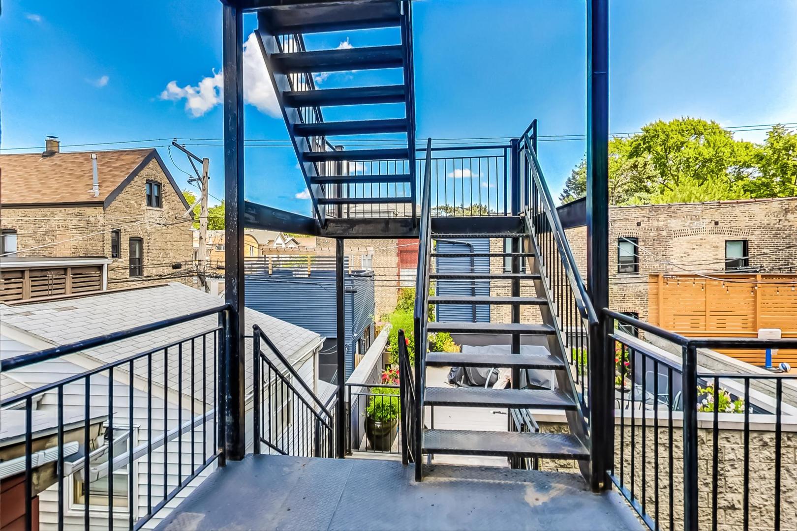 2035 North Leavitt Street, Unit 2 Chicago, IL 60647 - Photo 37 of 44 a view of staircase with railing and white walls