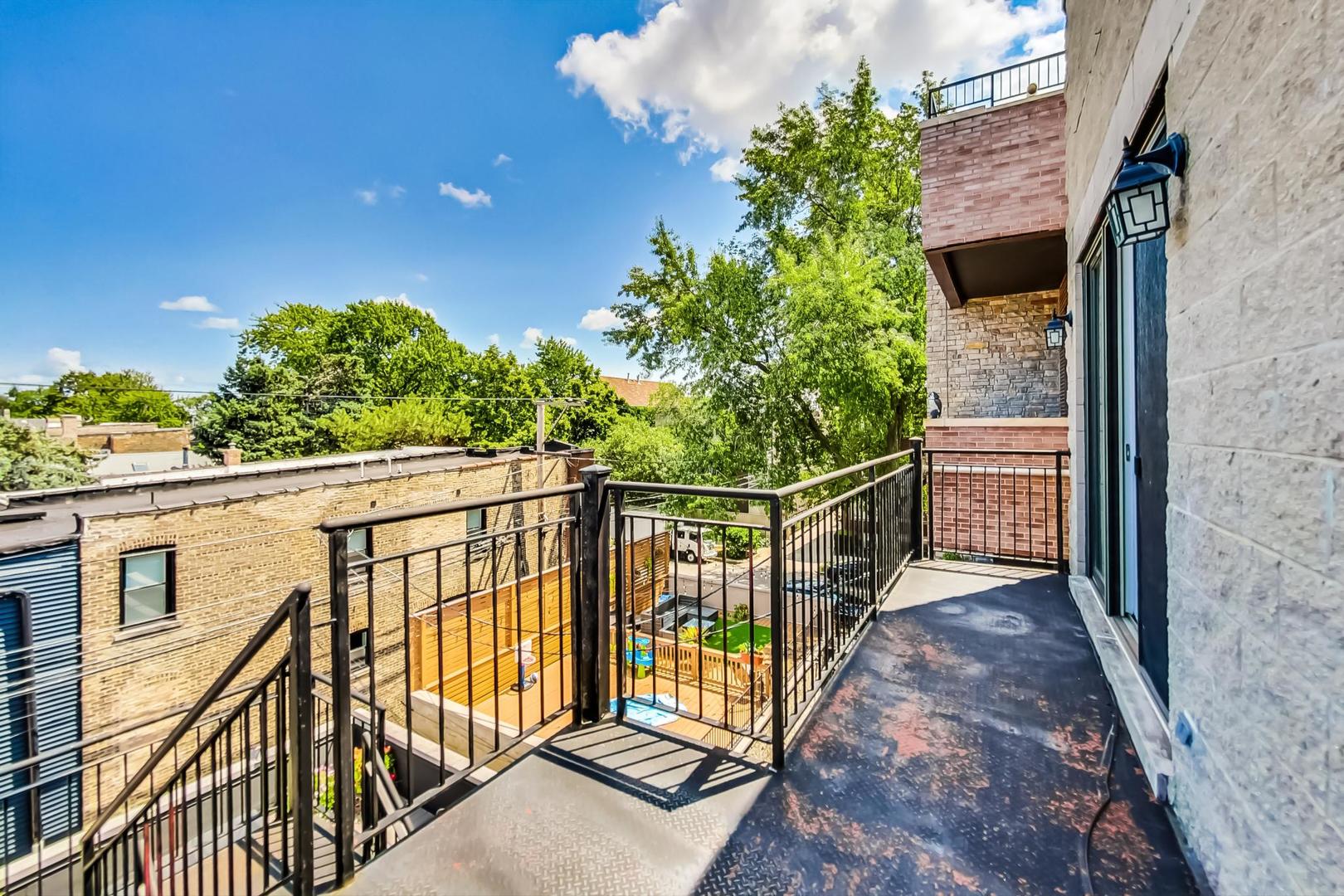 2035 North Leavitt Street, Unit 2 Chicago, IL 60647 - Photo 39 of 44 a view of a balcony with wooden fence