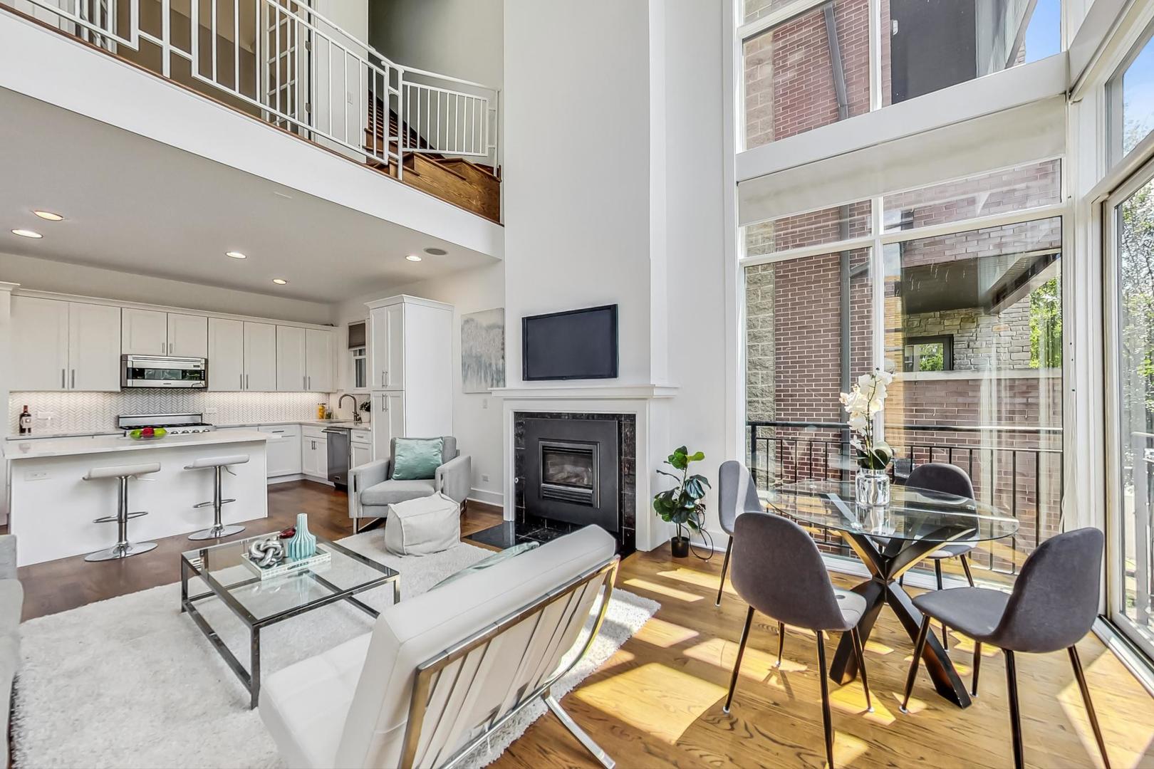 2035 North Leavitt Street, Unit 2 Chicago, IL 60647 - Photo 5 of 44 a living room with furniture a fireplace and a kitchen view
