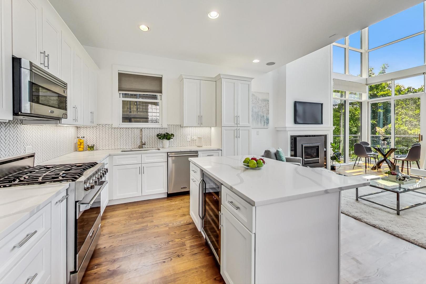 2035 North Leavitt Street, Unit 2 Chicago, IL 60647 - Photo 8 of 44 a utility room with stainless steel appliances granite countertop a stove top oven a sink dishwasher a refrigerator and white cabinets with wooden floor