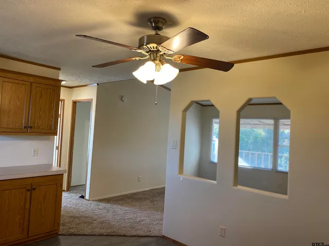 a view of a hallway with chandelier