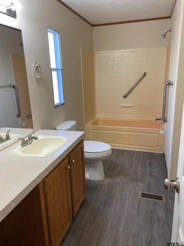 a bathroom with a double vanity sink toilet and shower