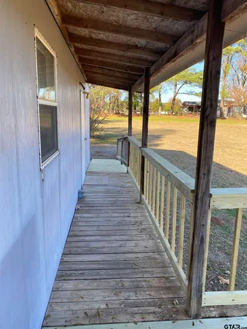 a view of a porch with wooden floor and outdoor space