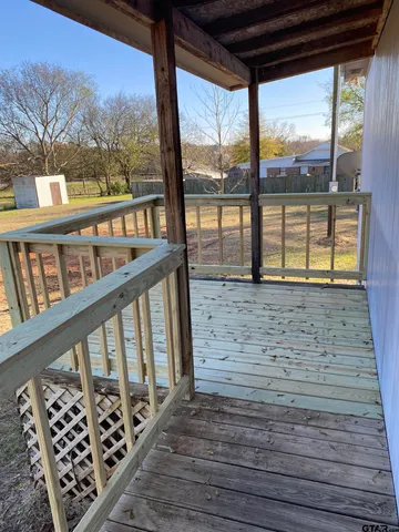 a view of porch with wooden floor and furniture