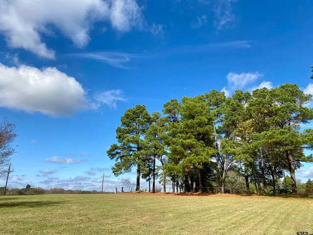 a view of a large body of water with a house in the background