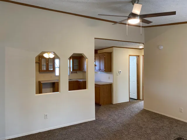 a view of a hallway with entryway cabinet mirror and a chandelier