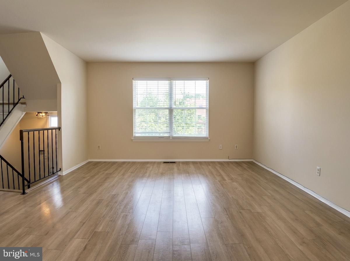 3614 Fawn Spring Court Baltimore, MD 21234 - Photo 14 of 22 an empty room with wooden floor and windows