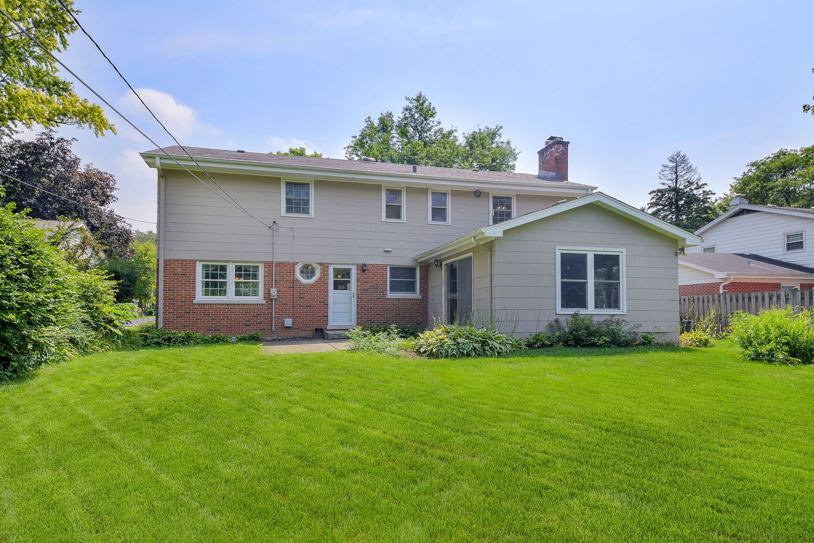 1344 South Main Street Wheaton, IL 60189 - Photo 17 of 20 a view of a yard in front of a house with plants and large tree
