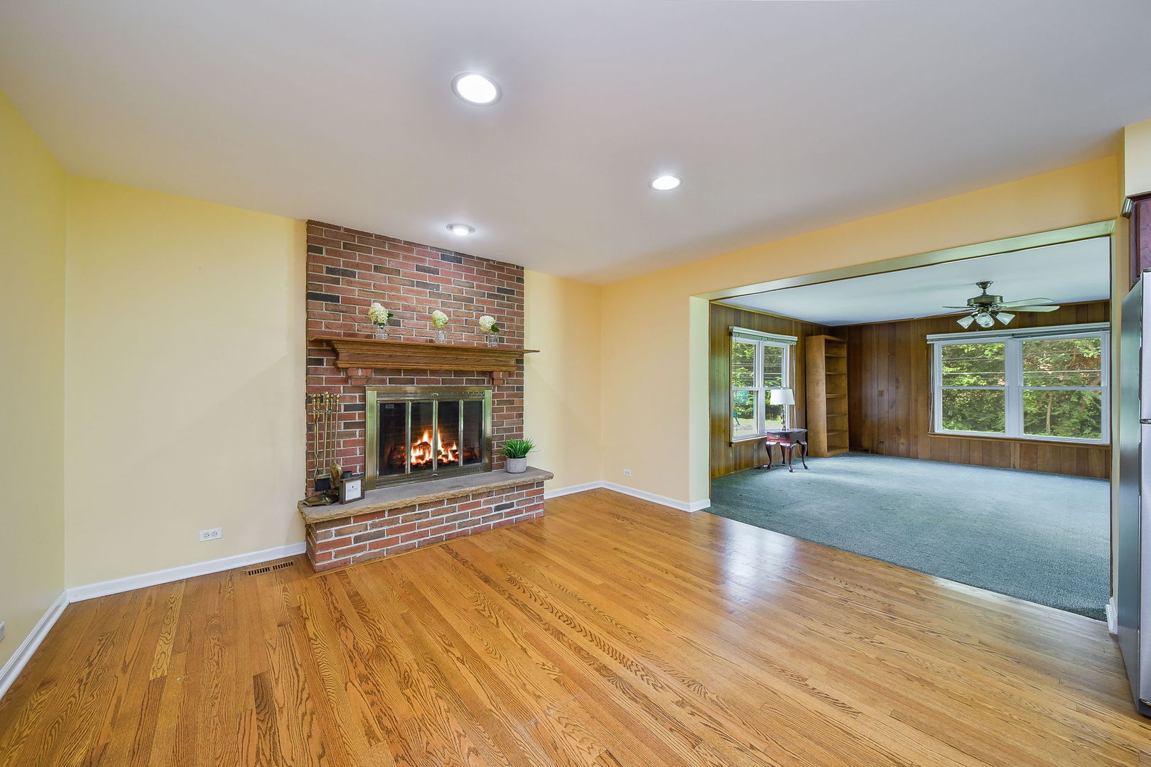 1344 South Main Street Wheaton, IL 60189 - Photo 5 of 20 a view of an empty room with a fireplace and a window