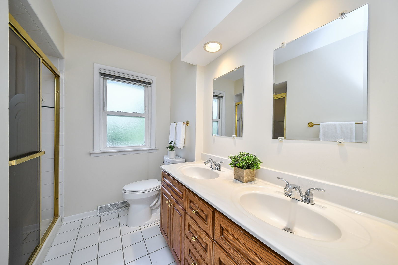 1344 South Main Street Wheaton, IL 60189 - Photo 10 of 20 a bathroom with a double vanity sink toilet and a mirror