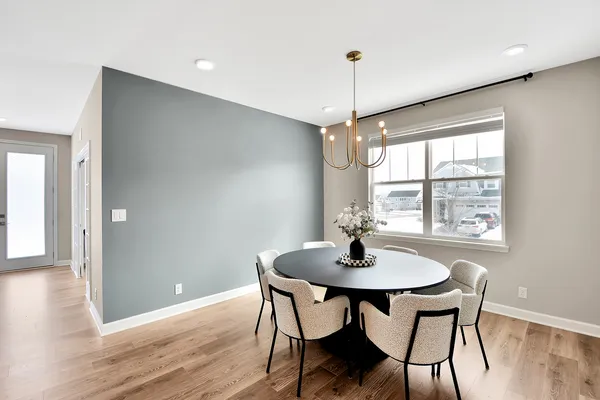 a living room with kitchen island furniture and a chandelier