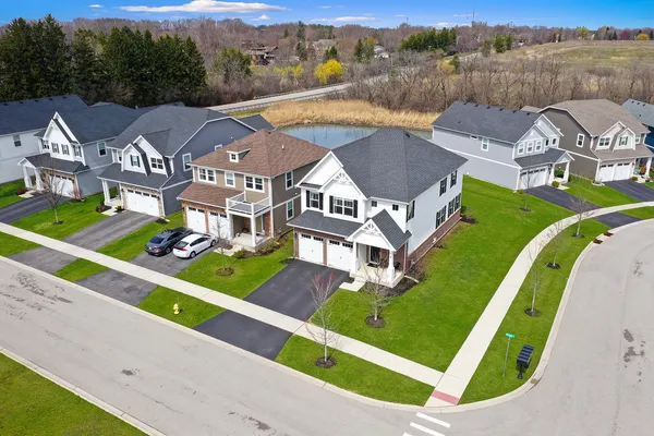 an aerial view of a house with a garden and lake view