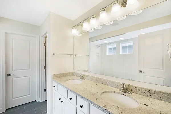 a bathroom with a window and a shower