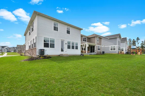 a view of a house with a yard and sitting area