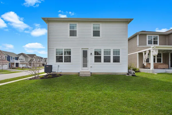 a front view of a house with a garden and yard