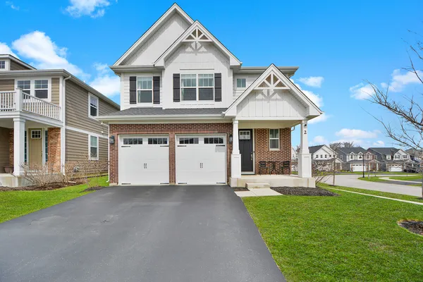 a front view of a house with a yard and garage