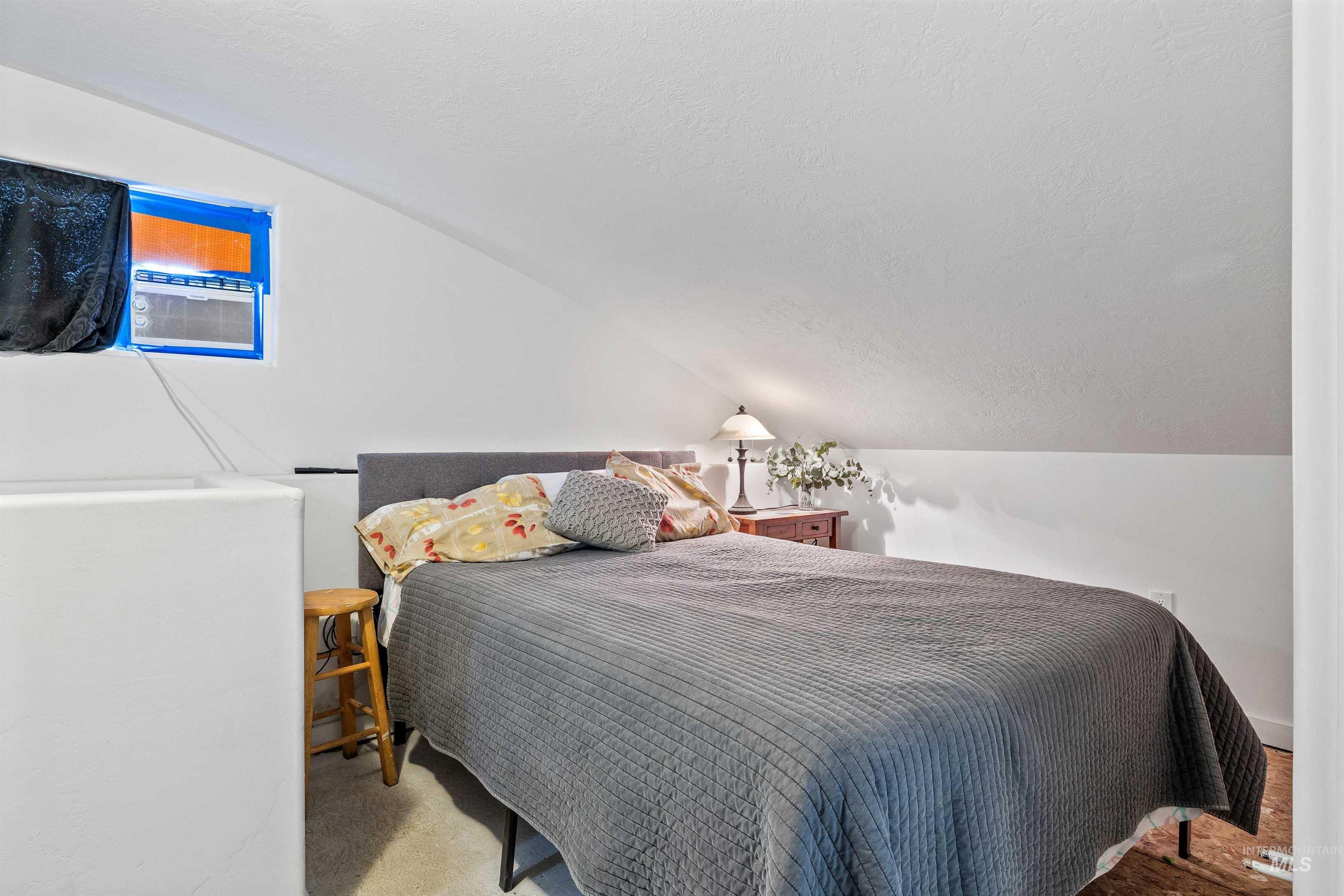 2039 Main Street Gooding, ID 83330 - Photo 15 of 31 Bedroom with vaulted ceiling and a textured ceiling