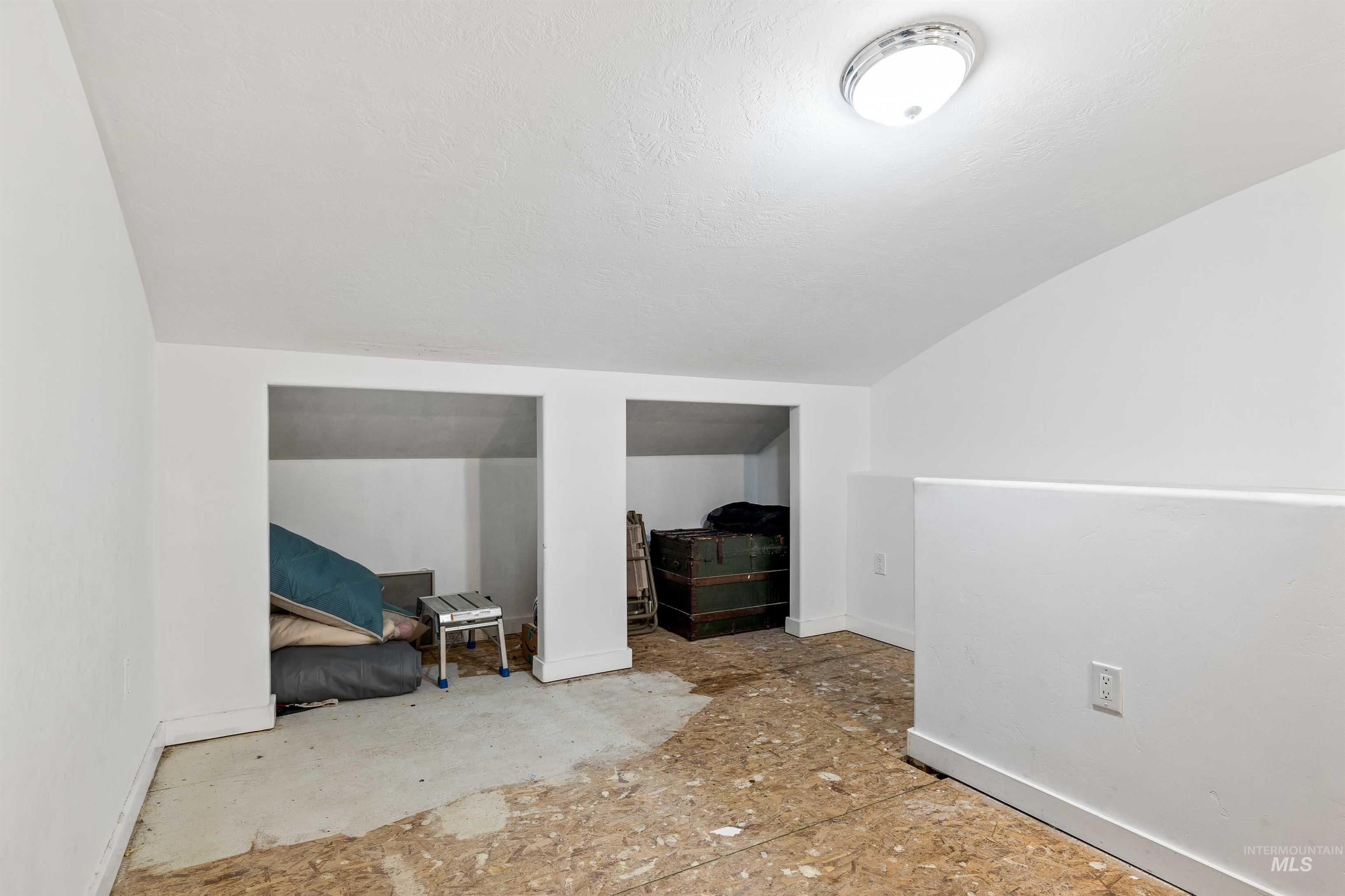 2039 Main Street Gooding, ID 83330 - Photo 17 of 31 Additional living space featuring lofted ceiling and a textured ceiling