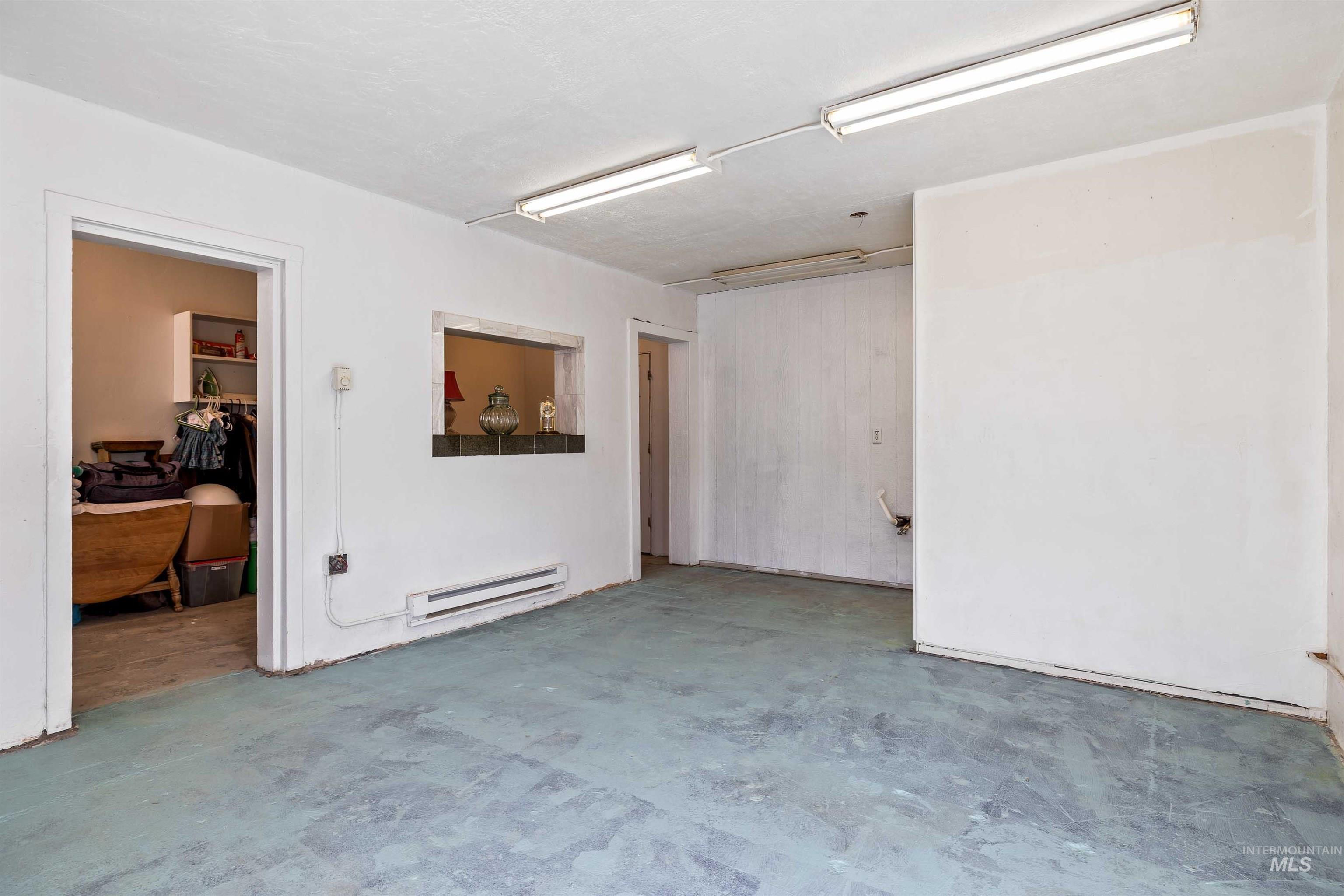 2039 Main Street Gooding, ID 83330 - Photo 19 of 31 Spare room featuring concrete floors and a baseboard heating unit