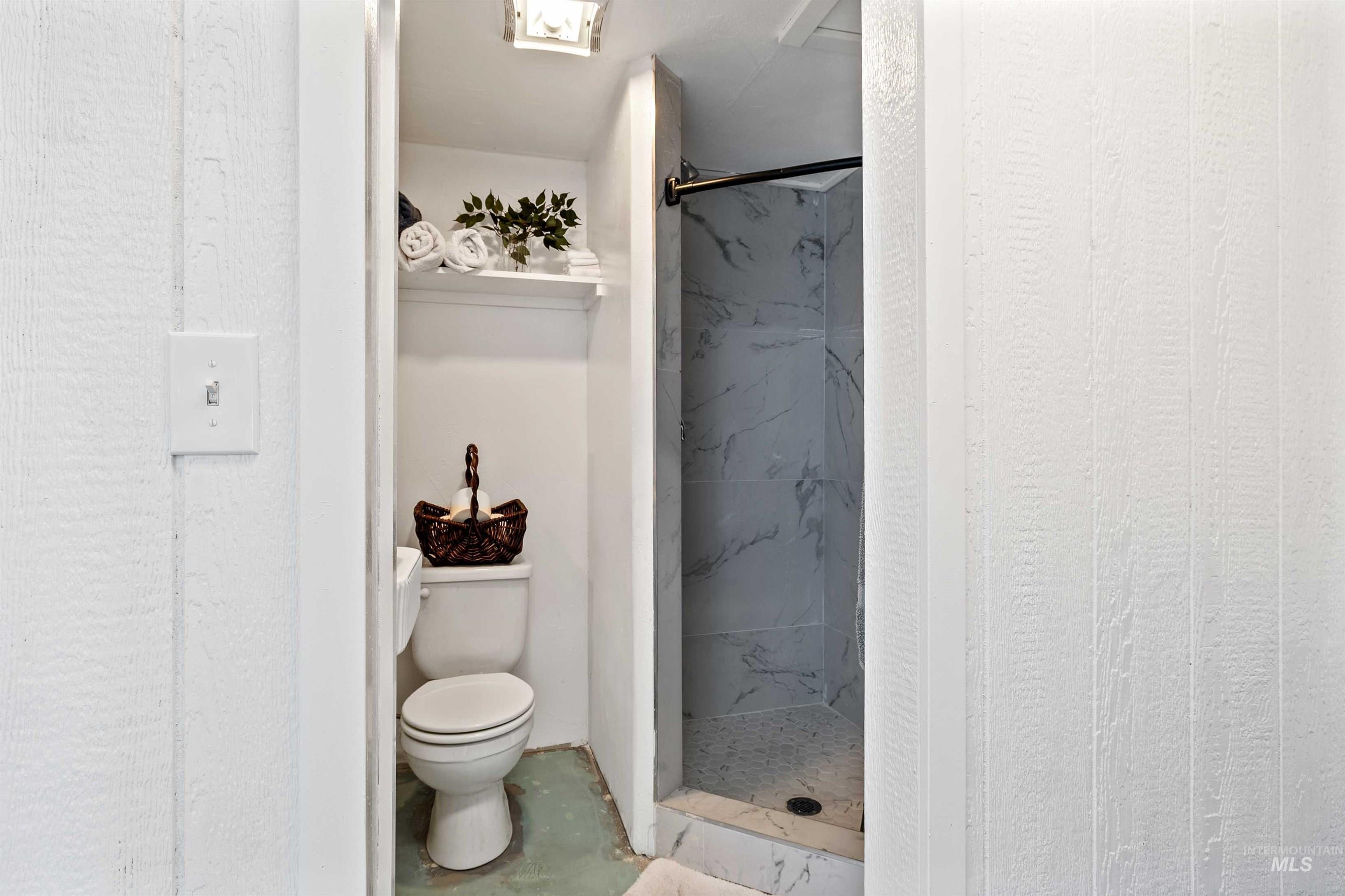 2039 Main Street Gooding, ID 83330 - Photo 21 of 31 Bathroom featuring toilet and a marble finish shower