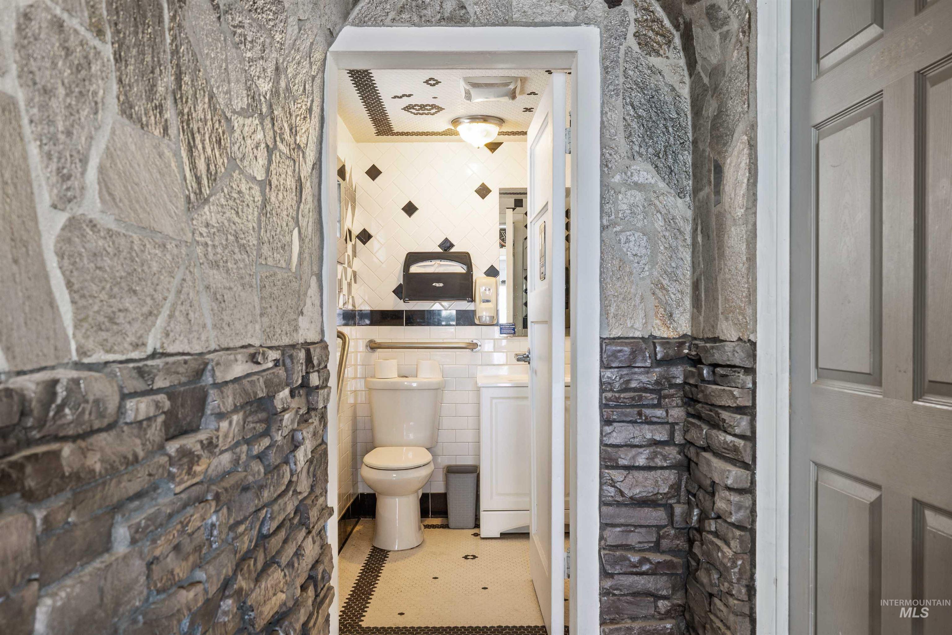 2039 Main Street Gooding, ID 83330 - Photo 9 of 31 Bathroom featuring toilet and tile walls
