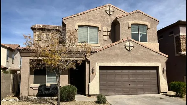 a front view of a house with garage