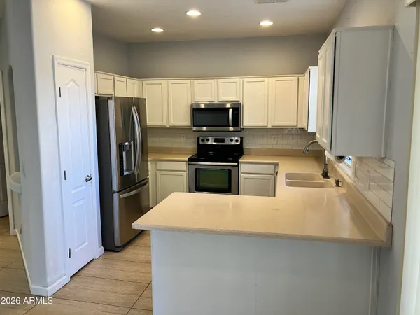 a kitchen with stainless steel appliances a refrigerator and a stove