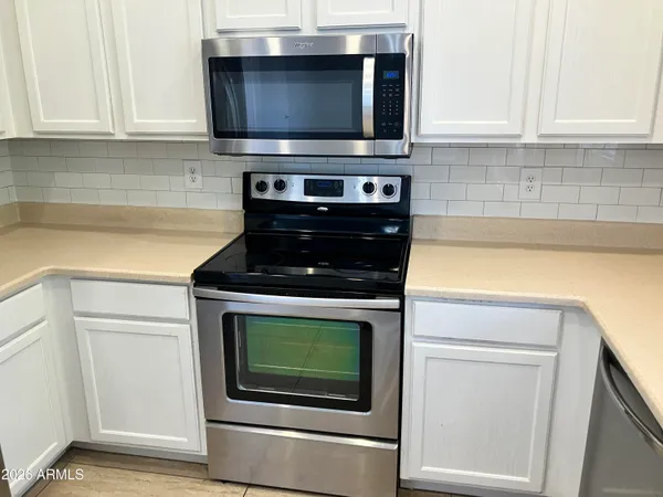 a kitchen with microwave stove and cabinets