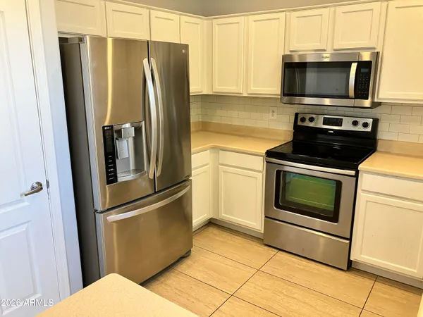 a kitchen with a refrigerator stove and microwave