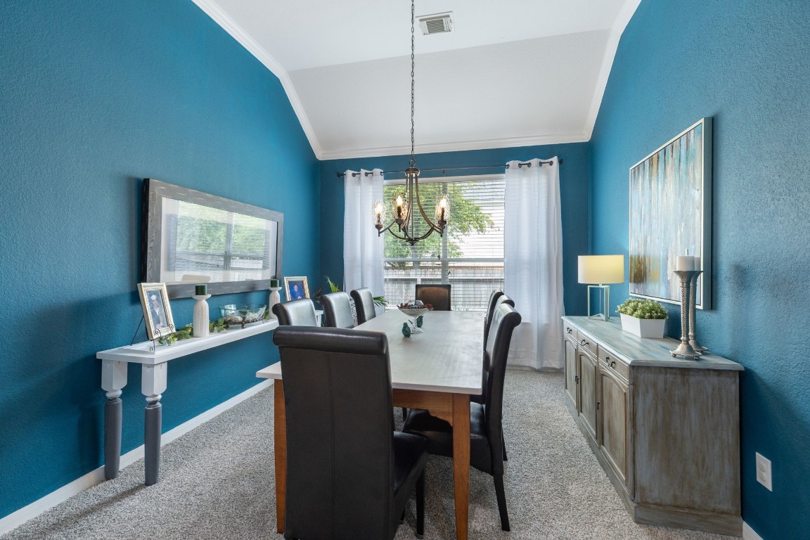 20410 Misty Crossing Lane Spring, TX 77379 - Photo 16 of 50 This photo showcases a dining room with a large window providing plenty of natural light, blue walls accent the elegant atmosphere, along with a high ceiling. The room is inviting and stylish making it perfect for entertaining.