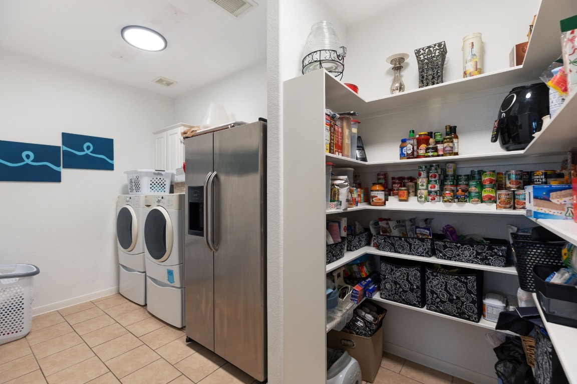 20410 Misty Crossing Lane Spring, TX 77379 - Photo 17 of 50 This combination pantry and laundry room provides plenty of space for storage and an additional refrigerator or freezer.