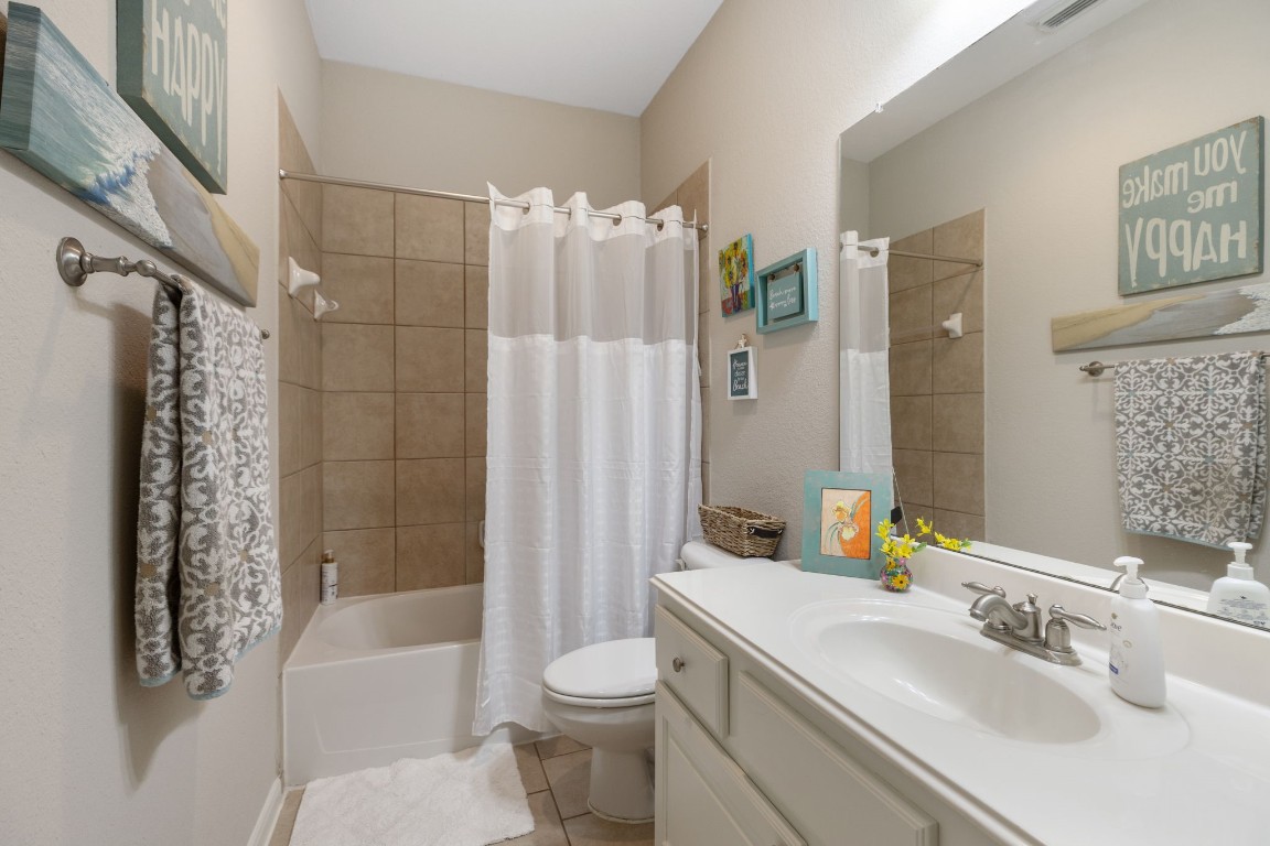 20410 Misty Crossing Lane Spring, TX 77379 - Photo 29 of 50 This bathroom is located by 2 of the bedrooms and has a tiled shower-tub combination. The space has neutral tones for a welcoming feel.