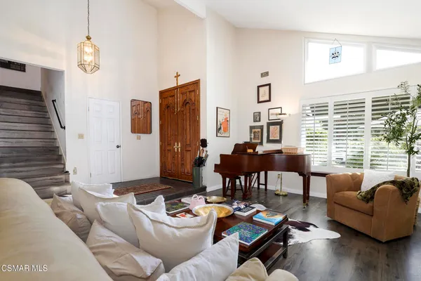 a living room with furniture and a large window