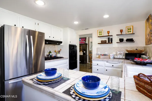 a kitchen with stainless steel appliances a refrigerator and stove