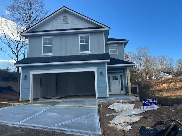 a front view of a house with garage