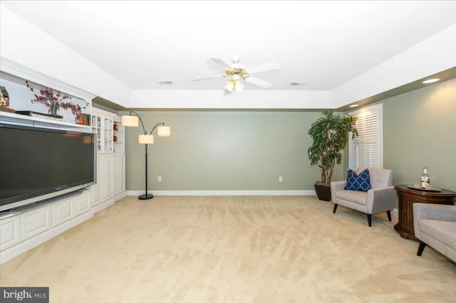 a bathroom with a granite countertop toilet sink and mirror