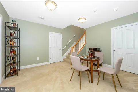 a bathroom with a granite countertop sink a toilet and with mirror