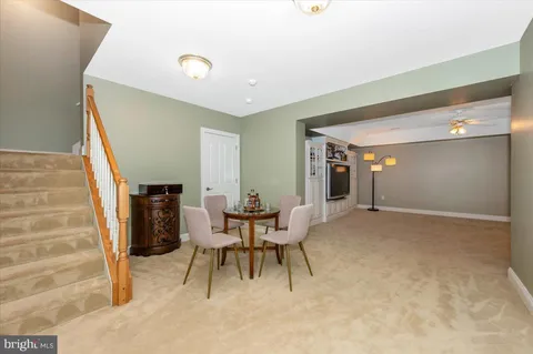 a work room with furniture and a potted plant