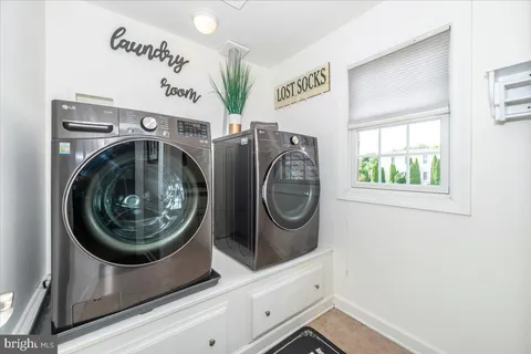a spacious bedroom with a bed and a chandelier