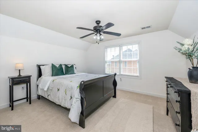 a spacious bedroom with a bed and a walk in closet